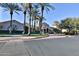 A street view of the community clubhouse featuring manicured landscaping and plenty of parking at 27138 W Escuda Dr, Buckeye, AZ 85396