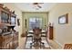 A traditional dining room showcases a wood table set, tiled floors, and decorative wood furnishings at 27138 W Escuda Dr, Buckeye, AZ 85396