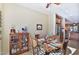 Dining room with a wooden round table, decorative hutch and a view into the kitchen at 27138 W Escuda Dr, Buckeye, AZ 85396