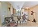 View of the kitchen bar area with seating, adjacent to a cozy living space at 27138 W Escuda Dr, Buckeye, AZ 85396