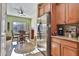 Kitchen with stainless steel refrigerator, adjacent to dining area with natural light at 27138 W Escuda Dr, Buckeye, AZ 85396