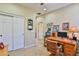 Home office space with a wooden desk, shelving, and a closet at 27138 W Escuda Dr, Buckeye, AZ 85396