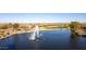 Scenic pond with a fountain on a golf course provides a beautiful view for surrounding homes at 27138 W Escuda Dr, Buckeye, AZ 85396