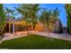 Landscaped backyard with a paver patio, synthetic grass, a pergola with lighting, creating an inviting outdoor retreat at 29219 W Clarendon Ave, Buckeye, AZ 85396