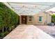 Paver patio with pergola, bordered by lush greenery, providing a serene outdoor living space, and easy home access at 29219 W Clarendon Ave, Buckeye, AZ 85396