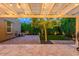 Backyard patio featuring string lights, a grill, egg chairs, and lush landscaping, perfect for entertaining at 29219 W Clarendon Ave, Buckeye, AZ 85396