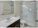 Bathroom with a glass-enclosed shower, a dark vanity, and an oval mirror at 29219 W Clarendon Ave, Buckeye, AZ 85396