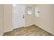 Entryway showcasing ceramic tile flooring, a white front door, and neutral wall paint at 29219 W Clarendon Ave, Buckeye, AZ 85396