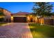 Beautiful single-Gathering home with a two-car garage, brick driveway, and manicured front yard landscaping at 29219 W Clarendon Ave, Buckeye, AZ 85396