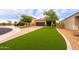 Charming single-Gathering home featuring a two-car garage, lovely brick driveway, and lush landscaping at 29219 W Clarendon Ave, Buckeye, AZ 85396