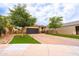 Beautiful single-Gathering home featuring a two-car garage, lovely brick driveway, and lush landscaping at 29219 W Clarendon Ave, Buckeye, AZ 85396