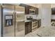 Close up of stainless steel appliances, granite countertops, and dark cabinets in the kitchen at 29219 W Clarendon Ave, Buckeye, AZ 85396