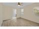 Living room with wood-look floors, a ceiling fan, and natural light from a window at 29219 W Clarendon Ave, Buckeye, AZ 85396