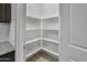 A walk-in pantry with floor-to-ceiling shelves provides ample storage space at 29219 W Clarendon Ave, Buckeye, AZ 85396