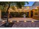 Inviting outdoor patio with string lights, a grill, and egg chairs, perfect for relaxing and entertaining at 29219 W Clarendon Ave, Buckeye, AZ 85396