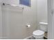 Powder room featuring toilet, towel rack, and modern fixtures at 29219 W Clarendon Ave, Buckeye, AZ 85396