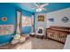 Vibrant Bedroom with blue walls, nautical decor, a crib, and plenty of natural light at 3049 E Santa Rosa Dr, Gilbert, AZ 85234