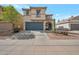 Charming two-story home featuring desert landscaping, a two car garage, and neutral earth-tone colors at 3049 E Santa Rosa Dr, Gilbert, AZ 85234