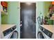 A compact laundry room with storage shelves and modern washer and dryer units at 3049 E Santa Rosa Dr, Gilbert, AZ 85234