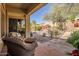 Relax on the patio with desert landscaping, stone pavers, and views of the private backyard oasis at 3108 W Ravina Ln, Anthem, AZ 85086