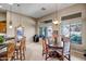 Dining room features a wooden table with upholstered chairs and pendant lighting at 3108 W Ravina Ln, Anthem, AZ 85086