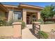 Inviting front entrance with a secure gate, stone accents, mature landscaping, and a covered porch at 3108 W Ravina Ln, Anthem, AZ 85086