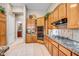 Well-lit kitchen with wooden cabinets, granite countertops, and modern appliances at 3108 W Ravina Ln, Anthem, AZ 85086