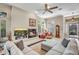 Bright living room with fireplace, ceiling fan and a comfortable sectional sofa with throw pillows at 3108 W Ravina Ln, Anthem, AZ 85086