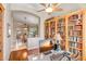 This stunning office space features custom bookshelves and a lovely view looking into the dining area at 3108 W Ravina Ln, Anthem, AZ 85086