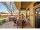 Covered patio with barbeque station, stone dining table, and desert views for outdoor enjoyment at 3108 W Ravina Ln, Anthem, AZ 85086