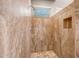 Walk-in shower featuring travertine walls, travertine floor and a built-in niche at 3108 W Ravina Ln, Anthem, AZ 85086