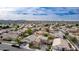 High-angle drone shot of a desert neighborhood with green landscaping and a distant mountain range at 3317 W Knudsen Dr, Phoenix, AZ 85027