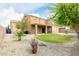 Landscaped backyard with gravel, grass, desert plants, and a cozy covered patio with a swing at 3317 W Knudsen Dr, Phoenix, AZ 85027