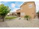 Large gravel-filled backyard features a covered patio with a swing and lush landscaping at 3317 W Knudsen Dr, Phoenix, AZ 85027