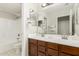 Neutral bathroom featuring a double sink vanity and shower-tub combo at 3317 W Knudsen Dr, Phoenix, AZ 85027