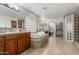 Spacious bathroom with double sinks, a bathtub, tile floors, and glass block at 3317 W Knudsen Dr, Phoenix, AZ 85027