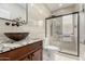 Elegant bathroom featuring a modern vanity with unique vessel sink and glass shower at 3317 W Knudsen Dr, Phoenix, AZ 85027