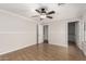 Spacious bedroom with a ceiling fan, neutral walls, and wood-look floors at 3317 W Knudsen Dr, Phoenix, AZ 85027