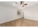 Cozy bedroom with a ceiling fan, light walls, and wood-look floors at 3317 W Knudsen Dr, Phoenix, AZ 85027