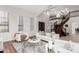 Bright and airy living room showcasing vaulted ceilings, spiral staircase, dark wood floors, and plush white furniture at 3317 W Knudsen Dr, Phoenix, AZ 85027