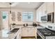 Close-up of the kitchen features stainless steel appliances, granite countertops and a door to the outside at 3399 E Open Prairie Dr, San Tan Valley, AZ 85140