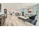 Open-concept living room with tile flooring, modern furniture, and a stylish chandelier at 3399 E Open Prairie Dr, San Tan Valley, AZ 85140