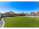 This home includes a backyard that features a privacy fence and artificial grass at 3903 E French Trotter St, San Tan Valley, AZ 85140