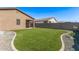 This backyard features artificial turf and a privacy fence at 3903 E French Trotter St, San Tan Valley, AZ 85140