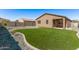 The home has an artificial grass backyard and a gravel border at 3903 E French Trotter St, San Tan Valley, AZ 85140