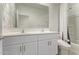 Bathroom featuring a double sink vanity, large mirror, white cabinets, and white trim at 3903 E French Trotter St, San Tan Valley, AZ 85140