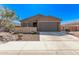 Single-story home featuring a two-car garage, stone accents, and desert landscaping at 3903 E French Trotter St, San Tan Valley, AZ 85140