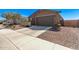 Single-story home featuring a two-car garage, stone accents, and desert landscaping at 3903 E French Trotter St, San Tan Valley, AZ 85140