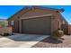 Single-story home featuring a two-car garage, stone accents, and low-maintenance landscaping at 3903 E French Trotter St, San Tan Valley, AZ 85140