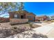 Single-story home featuring a two-car garage, stone accents, and desert landscaping at 3903 E French Trotter St, San Tan Valley, AZ 85140